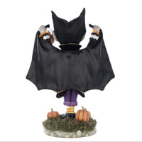 Rear view showcasing buffalo plaid cape with colorful trims and glitter embellishments.