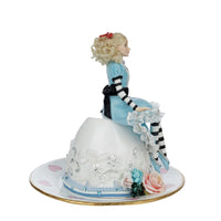 right side view of Hand-painted resin figurine Blue Alice on Teacup by Katherine’s Collection with striped tights and blue shoes