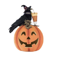 Front-facing view of Katherine’s Collection Crow with Pumpkin Tabletop showing the feathered crow, velvet pumpkin, and glowing jack-o’-lantern face.