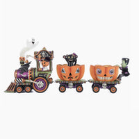 Full front view of the three-piece Halloween train featuring a jack-o’-lantern conductor and velvet pumpkin cars.