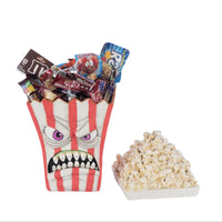 Popcorn bucket with candy and popcorn on a white background