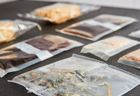 Close-up of organic rice noodles, sauce, garlic, herbs, and peanuts included in kit