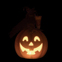 Carved pumpkin with a jack-o'-lantern face on a dark background, featuring Halloween icons.