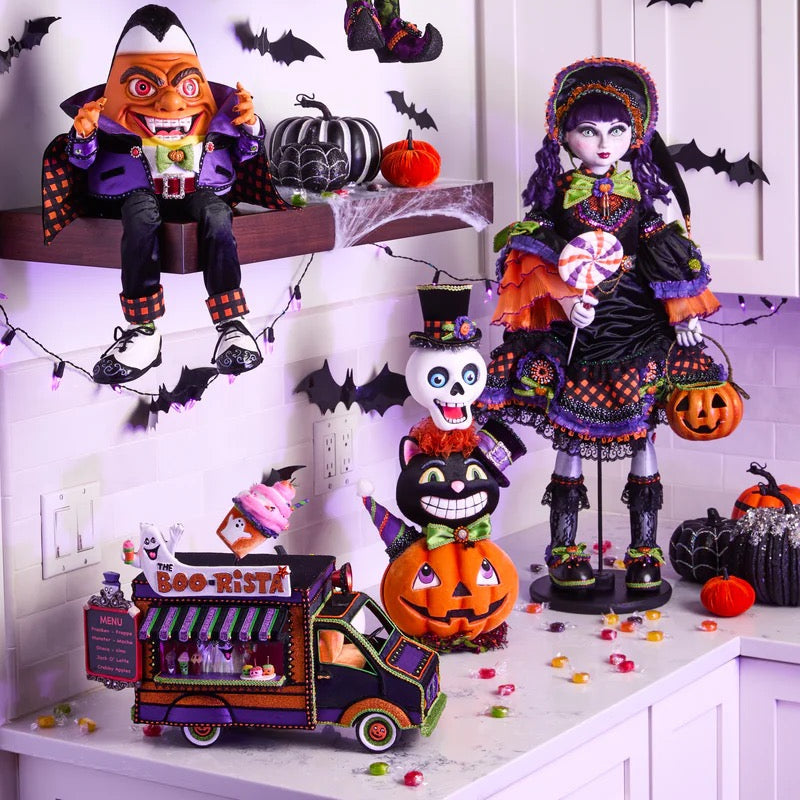 Halloween-themed decorations including dolls, pumpkins, and a truck on a shelf.