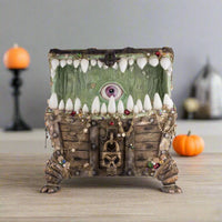 Top view of open Halloween candy container filled with pirate-themed treasure accents