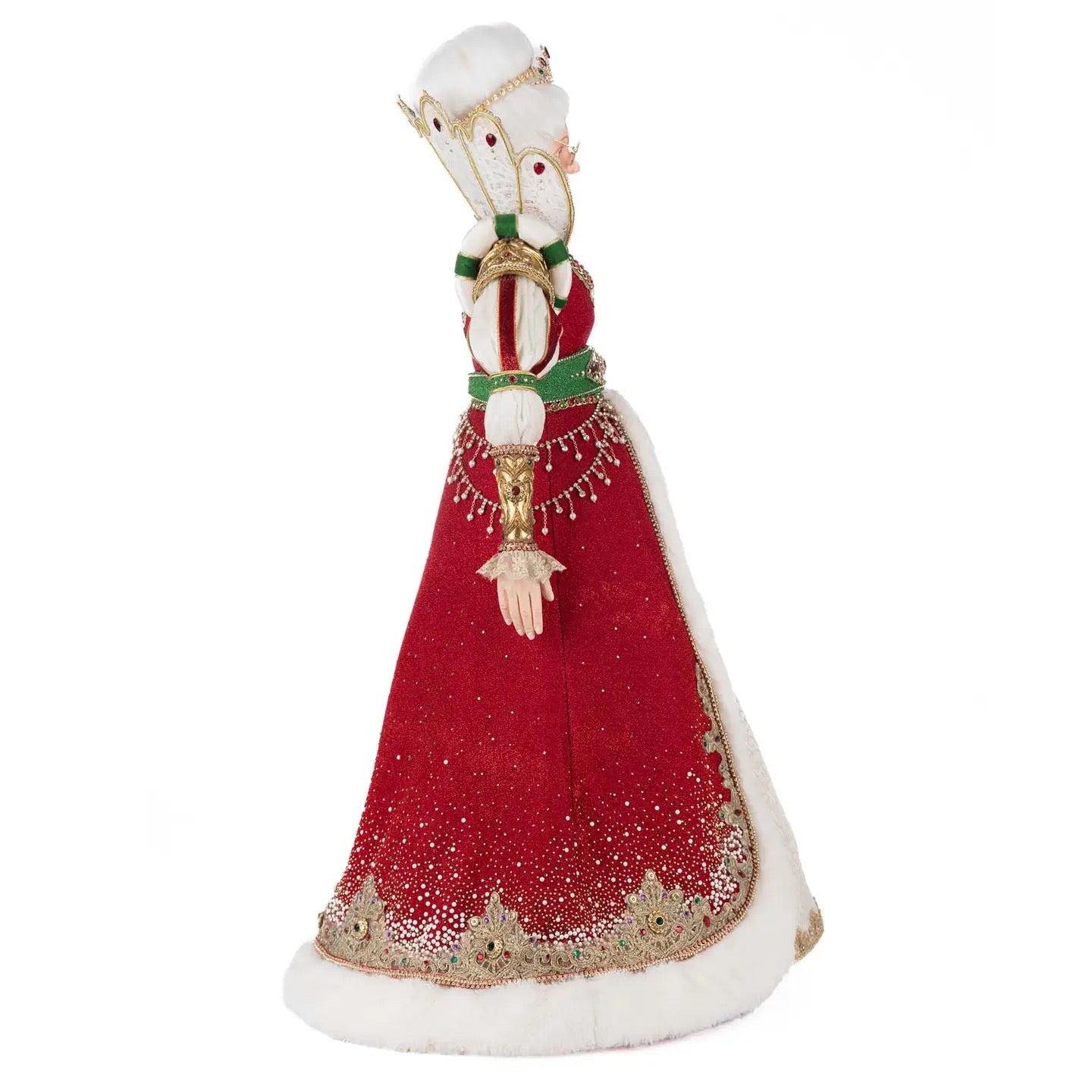 Side profile of Queen Noelle Claus holiday decoration showcasing intricate gemstone embellishments and gold crown with tassel detail