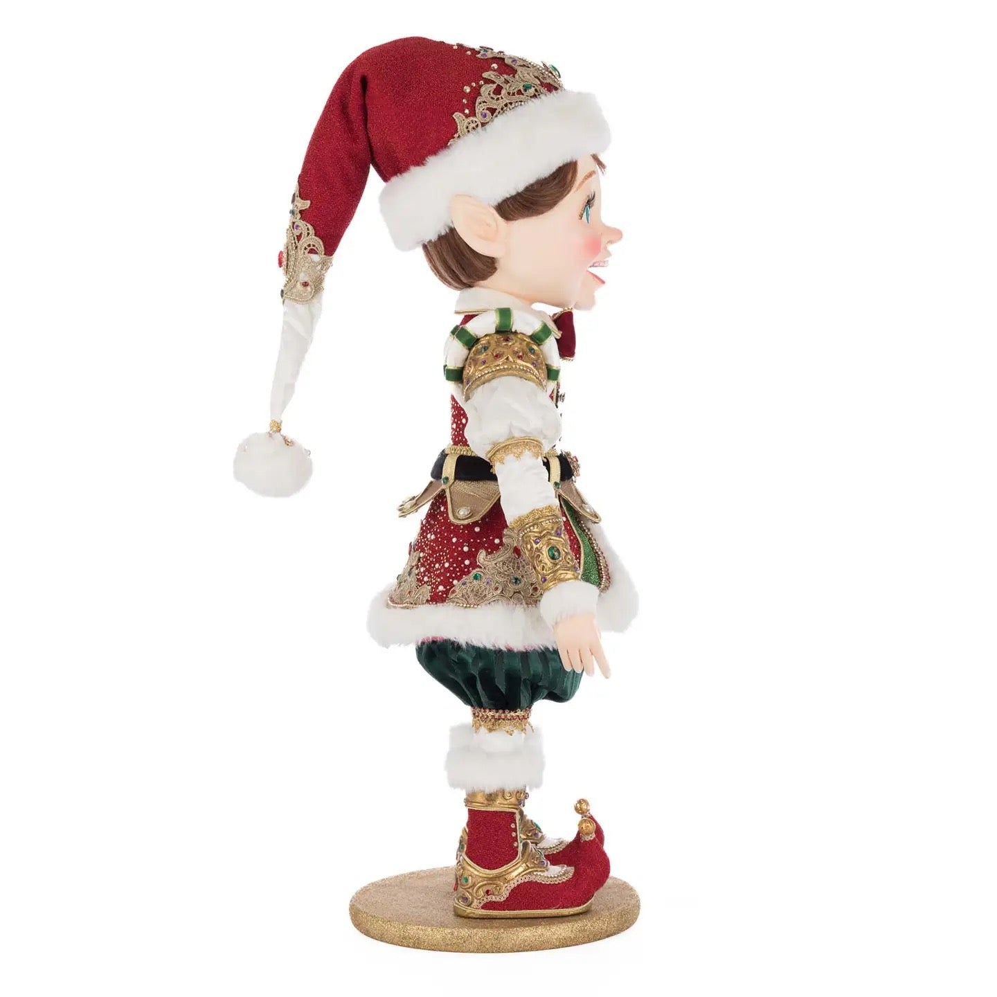 Close-up of William Wintersnap’s red elf hat with gold brocade and fluffy faux fur from Katherine’s Collection 2025 holiday collection