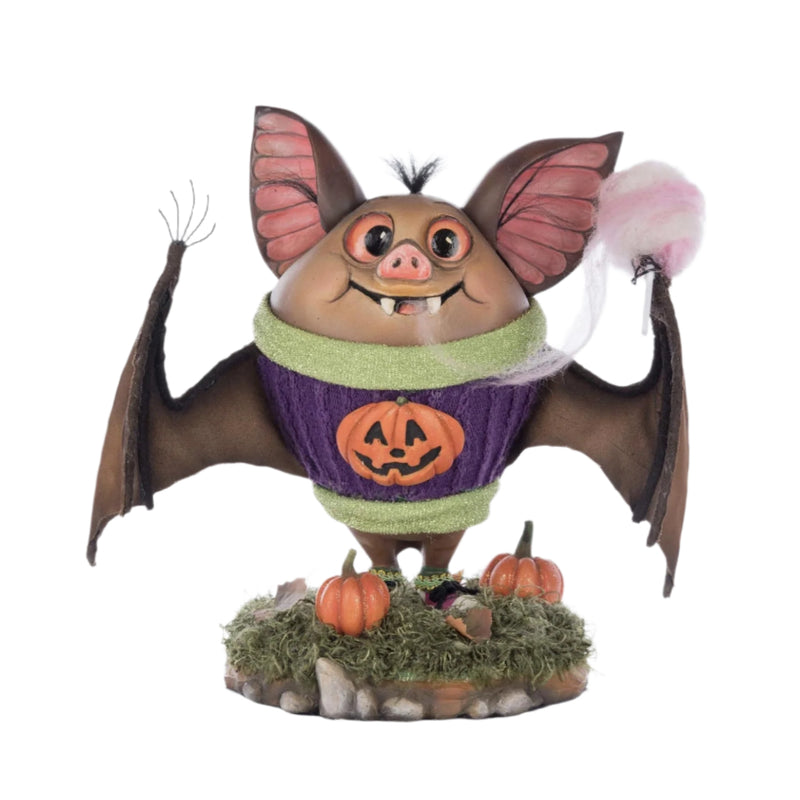 Front-facing view of Fangs the Bat, from Katherines Collection 2025 Halloween Collection showing cotton candy, glitter sweater, and pumpkins at his feet.