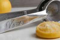 Handcrafted Mexican citrus juicer surrounded by fresh lemons