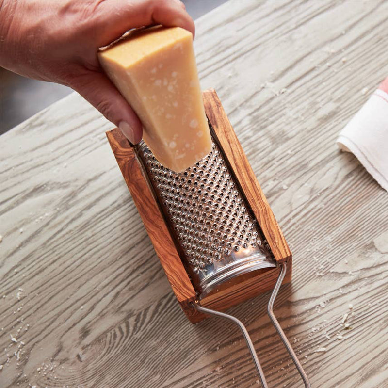 Detailed side angle showing the metal grater and olive wood catch box