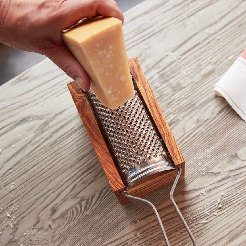 Detailed side angle showing the metal grater and olive wood catch box