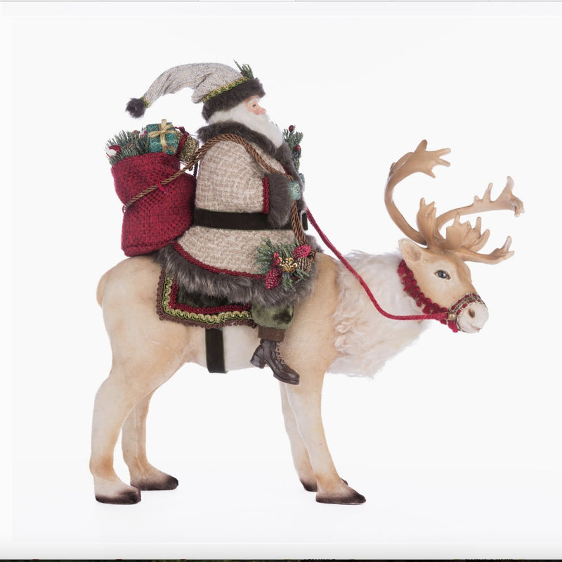 Santa Riding Caribou figurine styled in Christmas decor, Katherine’s Collection SKU 28-428269, GTIN 810074127820.