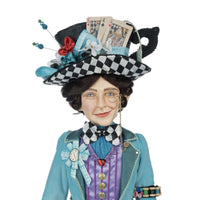 Katherine’s Collection Mad Hatter wearing blue jacket with armband holding spools of thread and buttons
