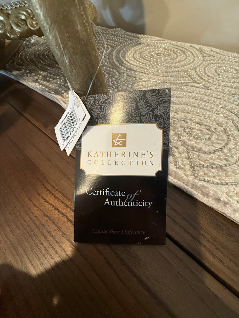 Katherine's Collection certificate of authenticity on a textured surface