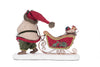 Sleigh filled with wrapped presents and greenery from Katherine’s Collection Santa Pulling Sleigh Candle Holder, SKU 28-428274, GTIN 810074127868