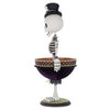 Description: Side profile of Billy Bones holding his fabric-lined bowl. Shows sculptural detail and costuming from shoulder to base.