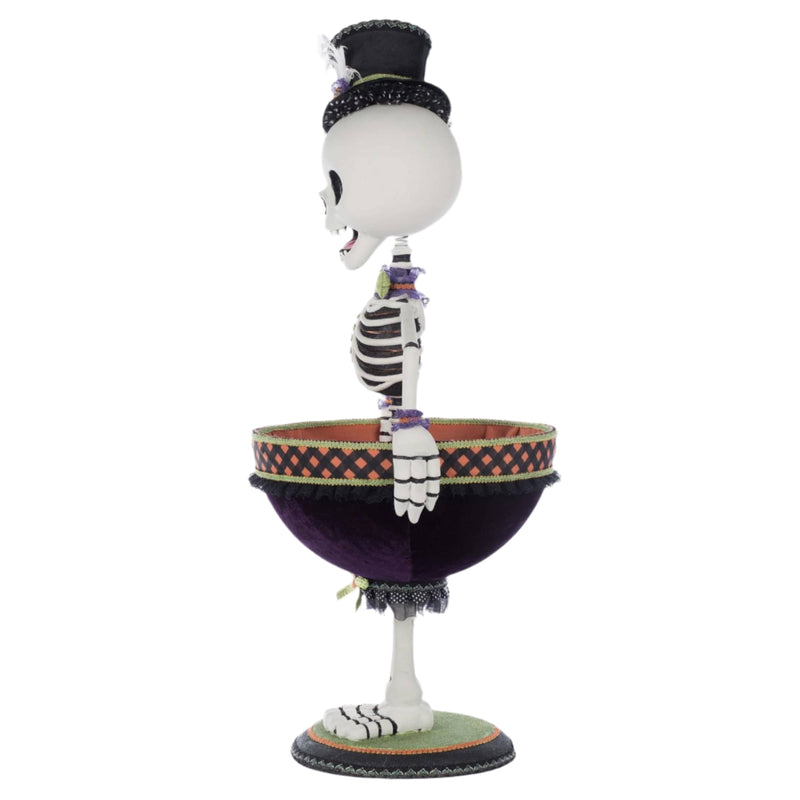 Description: Side profile of Billy Bones holding his fabric-lined bowl. Shows sculptural detail and costuming from shoulder to base.