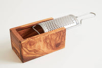 Detailed side angle showing the metal grater and olive wood catch box