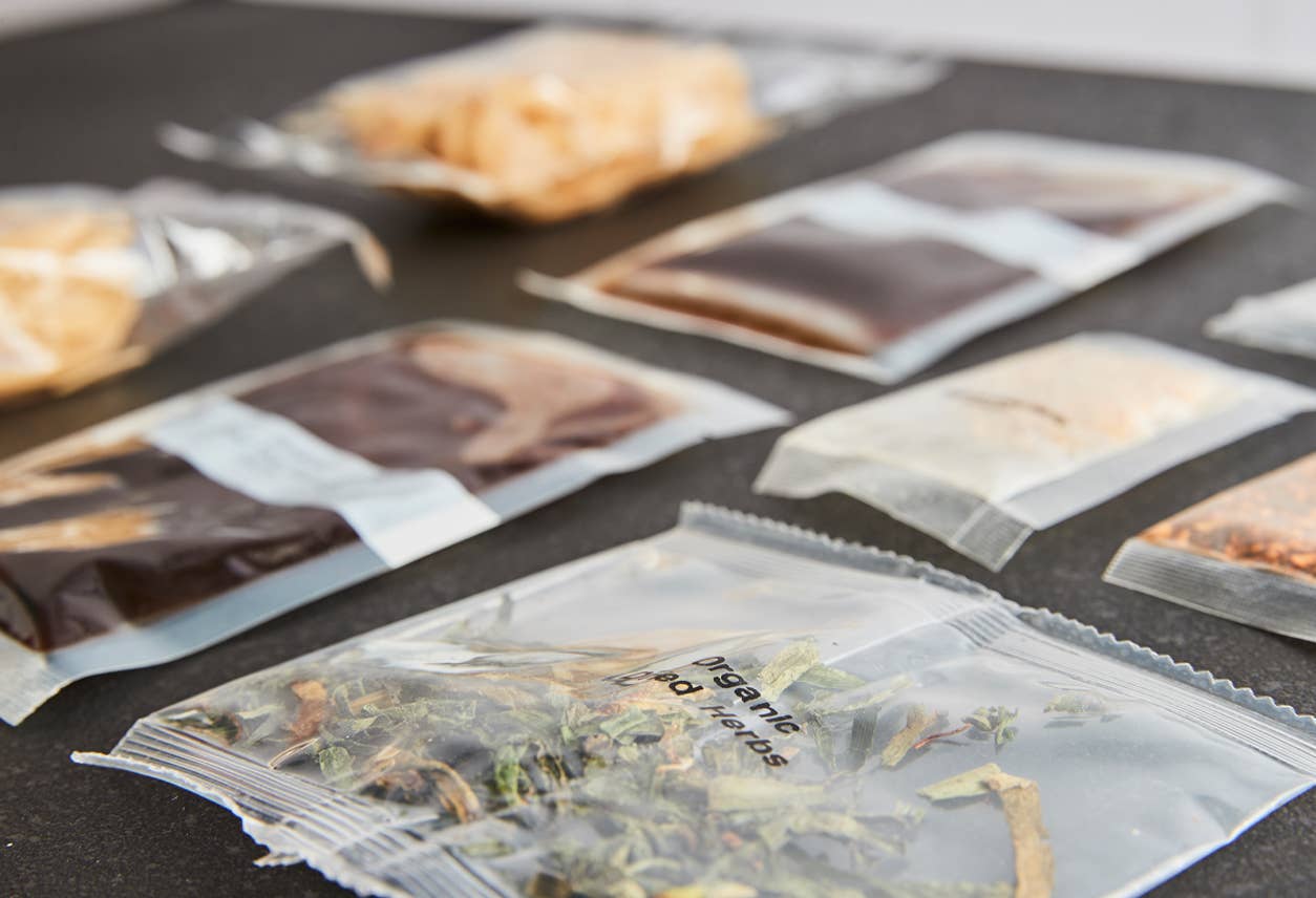 Close-up of organic rice noodles, sauce, garlic, herbs, and peanuts included in kit