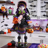 Halloween-themed doll with colorful outfit and pumpkin, set against a festive background.