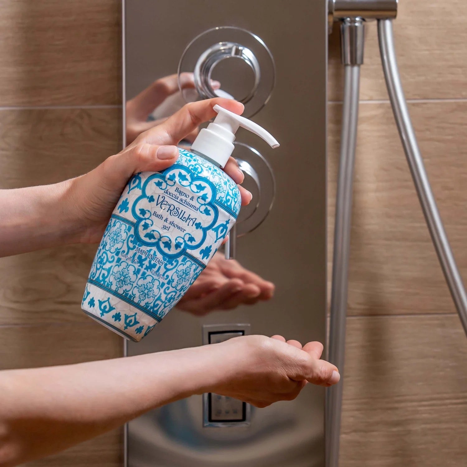 Person applying soap from a pump bottle of Rudy Profumi Versilia Bath and Shower Gel in a shower 