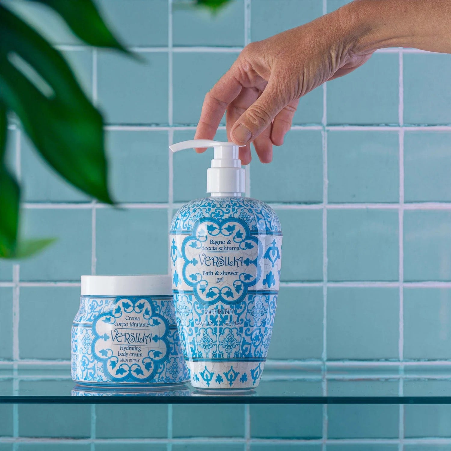 Rudy Profumi Versilia Bath and shower gel with pump and jar on a tiled bathroom counter next to a Versilia Hydrating Body Cream