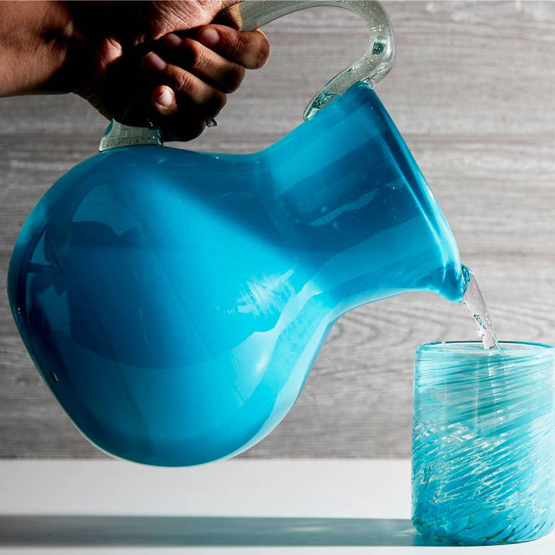 Aqua pitcher pouring water into matching handblown glasses