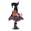 Colorful witch figurine with a hat and skirt on a white background