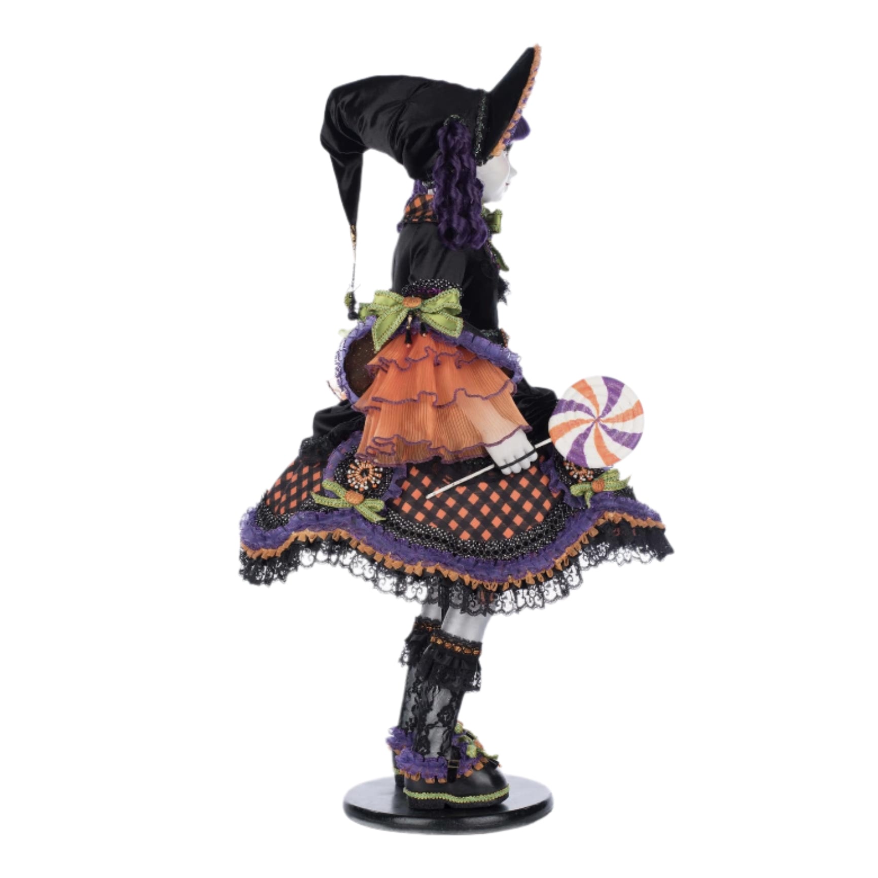 Colorful witch figurine with a hat and skirt on a white background