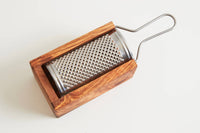 Eco-friendly Italian olive wood grater displayed on kitchen counter