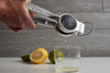Verve Culture hand juicer displayed on a kitchen counter with lemons and limes