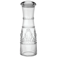 Clear polycarbonate carafe with decorative patterns on a white background from Baci Milano
