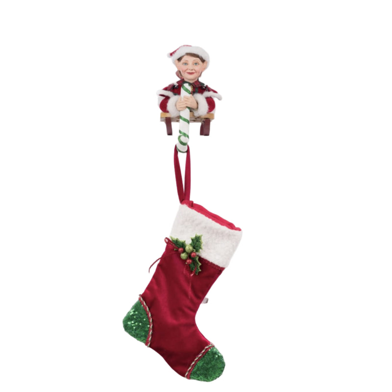 Holiday Magic Laying Elf on Sled Stocking Holder displayed on a Christmas mantel