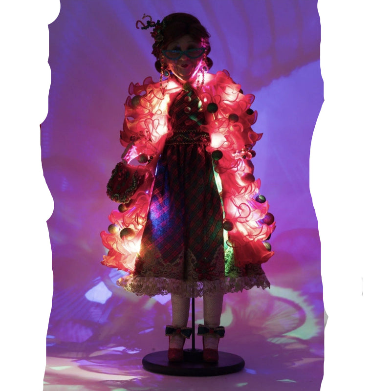 Lit for night, the katherines collection Holiday Magic Mae doll holding poinsettia handbag with festive holiday details