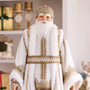 Man in a traditional Russian Christmas costume standing in a decorated room with a Christmas tree and gifts.