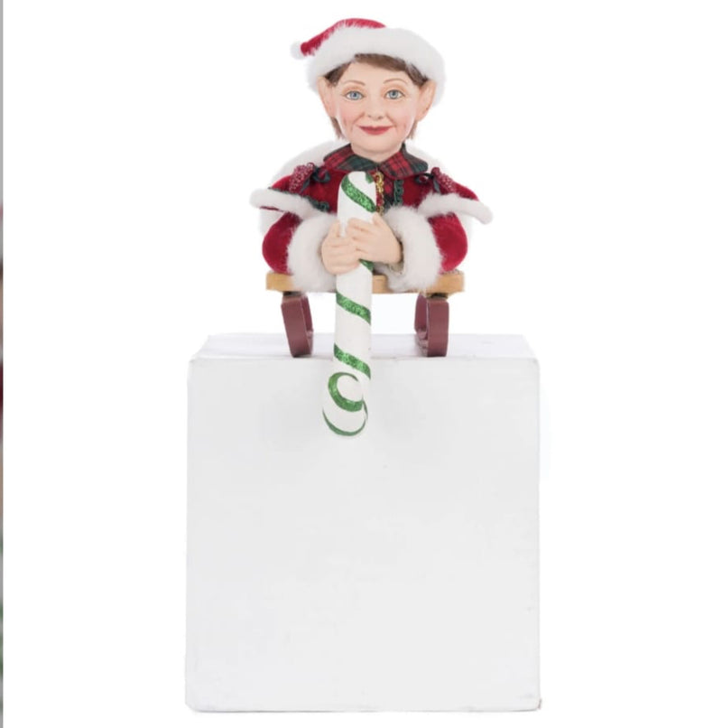 Front view of Katherine’s Collection Holiday Magic Laying Elf on Sled Stocking Holder