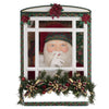 Decorative holiday window with Santa Claus figure and festive decorations on a white background.