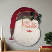 Decorative head of a Santa Claus with a red hat and plaid band on a white background