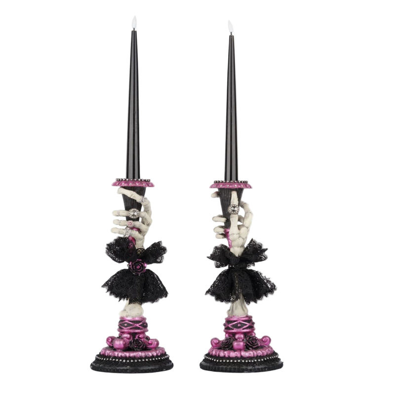 Side B view of Katherine’s Collection Skeleton Hand Candle Stick, resin skeleton hand holding battery-operated black candle.