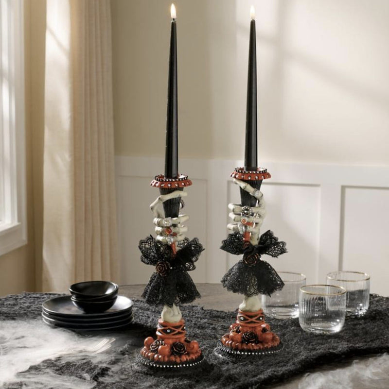 
Pair of Katherine’s Collection Skeleton Hand Candle Sticks displayed on a tabletop, Halloween centerpiece décor.