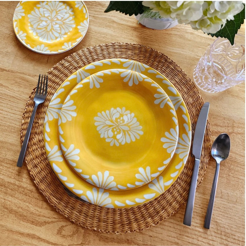 Le Cadeaux Paloma yellow floral melamine outdoor  plates with silverware on a Sicily Orange disposable placemat
