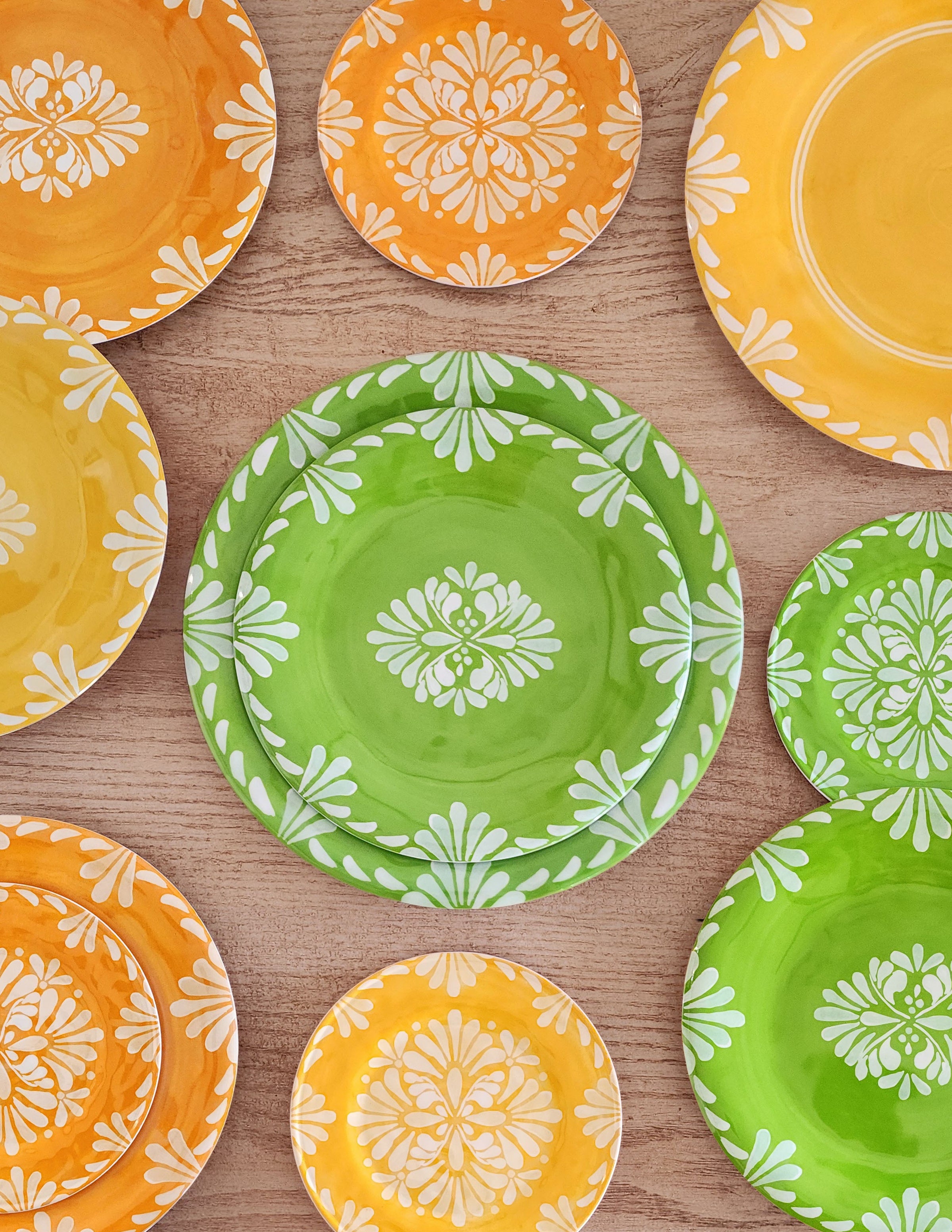 Le Cadeaux PALOMA GREEN, Orange, Yellow dinner plates, salad plates, appetizer, plates.  Colorful indoor outdoor Melamine plates with floral patterns on a wooden surface