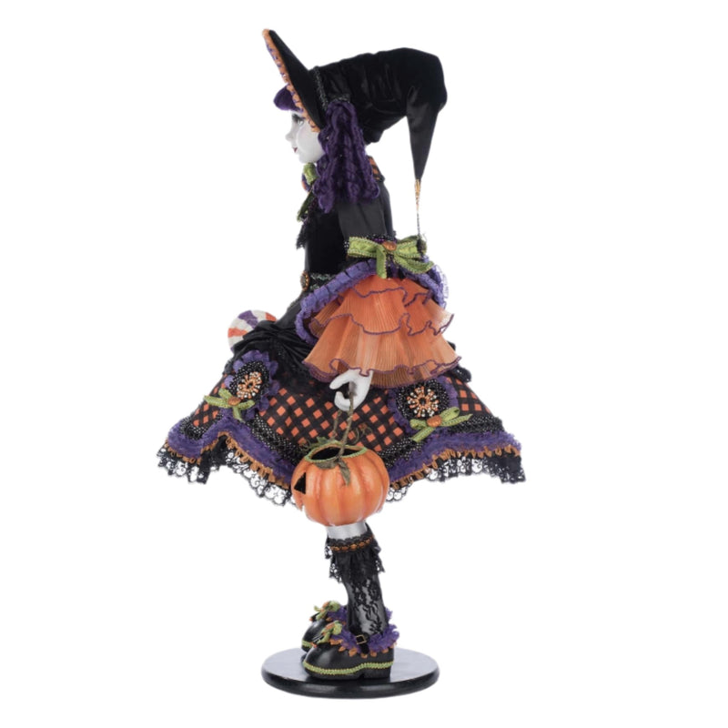 Halloween-themed figurine with a witch costume and pumpkin on a white background